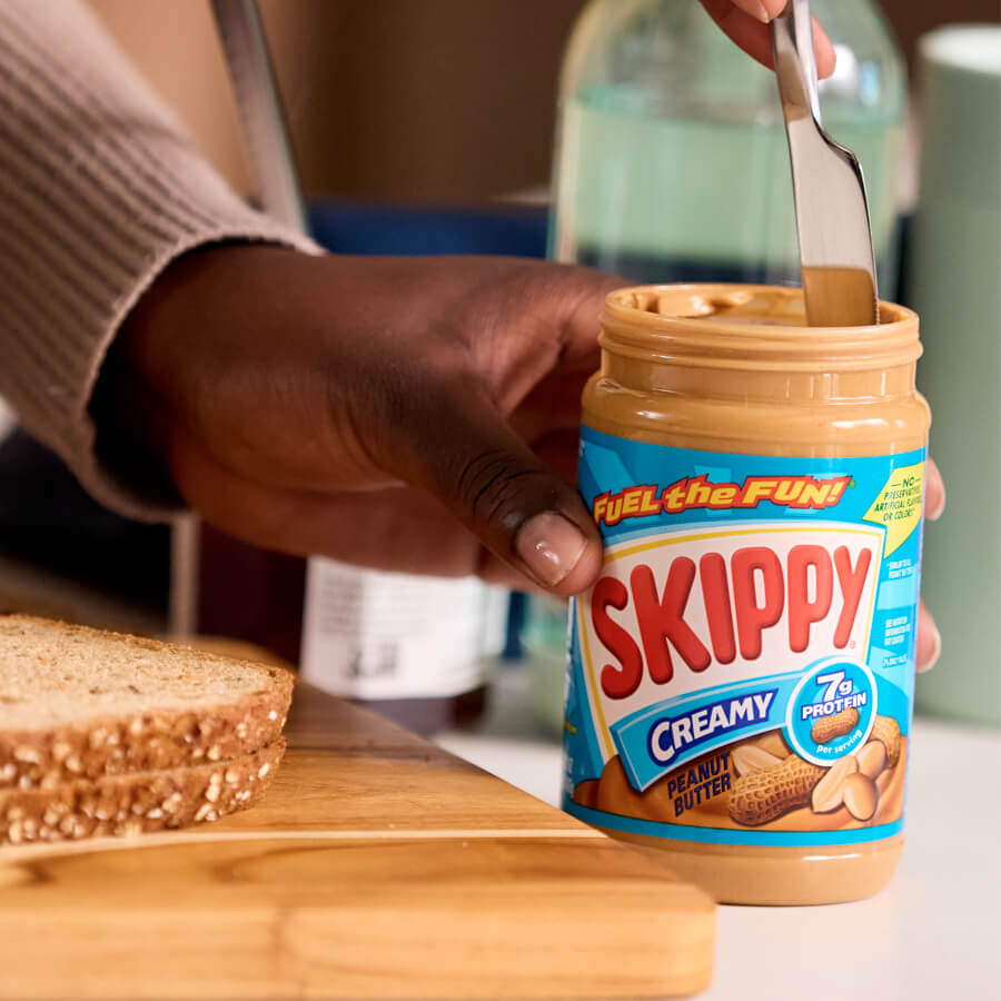 skippy jar with hands and bread